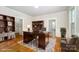 Spacious office with a large wooden desk, built-in shelves, and hardwood floors at 116 Rose Ter, Wadesboro, NC 28170