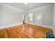 Bright room with hardwood floors, white trim, and doors leading to other rooms at 116 Rose Ter, Wadesboro, NC 28170