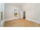 Bright room with light wood floors, white trim, and view through a window at 116 Rose Ter, Wadesboro, NC 28170