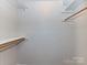 Empty walk-in closet featuring rod and shelf storage and bright walls at 1323 Queens Rd # 308, Charlotte, NC 28207