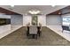 Elegant dining area with a modern table and chairs, complemented by a beautiful painting at 1323 Queens Rd # 308, Charlotte, NC 28207