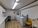 Clean laundry room featuring multiple machines, ample counter space, and utilitarian design at 1323 Queens Rd # 308, Charlotte, NC 28207