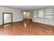 Living room featuring hardwood floors and custom built-in bookshelves and cabinets at 1323 Queens Rd # 308, Charlotte, NC 28207
