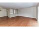 Spacious living room features hardwood floors and custom built-in bookshelves and cabinets at 1323 Queens Rd # 308, Charlotte, NC 28207