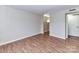 Unfurnished living room with hardwood floors and a doorway leading to another space at 1323 Queens Rd # 308, Charlotte, NC 28207