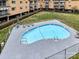 Aerial view of a community pool with a fenced perimeter and surrounding apartment buildings at 1323 Queens Rd # 308, Charlotte, NC 28207