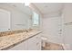 Well-lit bathroom features a granite vanity, toilet, and shower-tub combination at 1412 Meadow Ave, Kannapolis, NC 28083