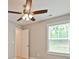 A bedroom features neutral carpet, ceiling fan, and a window with natural light at 1412 Meadow Ave, Kannapolis, NC 28083