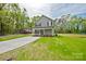 Beautiful two-story home with a front porch, a long driveway, and a well-manicured lawn, creating a welcoming curb appeal at 1412 Meadow Ave, Kannapolis, NC 28083