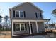 Charming two-story home with gray siding, black shutters, and inviting front porch at 1412 Meadow Ave, Kannapolis, NC 28083