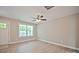 Light-filled living room with light-toned walls, wood-look floors, and a large window offering a bright view at 1412 Meadow Ave, Kannapolis, NC 28083
