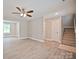 Comfortable living room with light-toned walls, wood-look floors, and natural light flowing through a window at 1412 Meadow Ave, Kannapolis, NC 28083