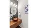 Stylish half bathroom with a unique vessel sink, modern lighting, and a sleek design at 14462 Holly Springs Dr, Huntersville, NC 28078