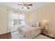 Well-lit bedroom featuring wallpaper and a comfortable bed by the window at 14462 Holly Springs Dr, Huntersville, NC 28078