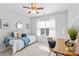 Bright bedroom with a ceiling fan and window offering natural light at 14462 Holly Springs Dr, Huntersville, NC 28078