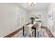 Well-staged dining room with dark wood table, six chairs, a decorative rug, and access to the outdoors through French doors at 14462 Holly Springs Dr, Huntersville, NC 28078