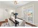 Dining room with dark wood table, six chairs, and French doors providing natural light and outdoor view at 14462 Holly Springs Dr, Huntersville, NC 28078