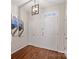 Bright entryway with wood floors, features a stylish light fixture and an adjacent closet at 14462 Holly Springs Dr, Huntersville, NC 28078