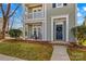 Inviting front porch features seating, a blue front door with wreath, and manicured landscaping for great curb appeal at 14462 Holly Springs Dr, Huntersville, NC 28078