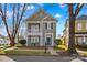 Charming two-story home with a inviting covered porch and balcony, a beautiful yard, and a classic blue door at 14462 Holly Springs Dr, Huntersville, NC 28078