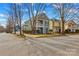 A charming two-story home with a porch and balcony sits on a corner lot in a neighborhood with sidewalks at 14462 Holly Springs Dr, Huntersville, NC 28078