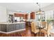 Spacious kitchen with stainless steel appliances, granite countertops, and adjacent dining area at 14462 Holly Springs Dr, Huntersville, NC 28078