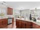 Bright kitchen with stainless steel appliances, dark wood cabinets, granite countertops and an island at 14462 Holly Springs Dr, Huntersville, NC 28078