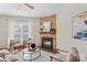 Comfortable living room with a stone fireplace, a ceiling fan, and natural light at 14462 Holly Springs Dr, Huntersville, NC 28078