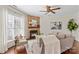 Bright living room features a stone fireplace, lots of natural light, and wood floors at 14462 Holly Springs Dr, Huntersville, NC 28078