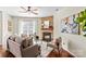 Cozy living room features a stone fireplace, lots of natural light, and wood floors at 14462 Holly Springs Dr, Huntersville, NC 28078