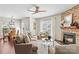 Cozy living room features a stone fireplace, lots of natural light, and wood floors at 14462 Holly Springs Dr, Huntersville, NC 28078