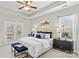 Comfortable main bedroom featuring a tray ceiling, a king bed with navy pillows, and access to a balcony at 14462 Holly Springs Dr, Huntersville, NC 28078