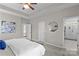 Spacious main bedroom with tray ceiling, neutral tones, and access to the ensuite bathroom with a glass shower at 14462 Holly Springs Dr, Huntersville, NC 28078