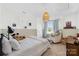 This cozy bedroom features a plush bed, chair, natural light and unique decor at 146 Allenton Way, Statesville, NC 28677