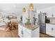 Modern kitchen with stainless appliances seamlessly connecting to living and dining areas at 146 Allenton Way, Statesville, NC 28677