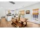 Well-lit kitchen features white cabinets, wooden dining table, and a door to the backyard at 146 Allenton Way, Statesville, NC 28677