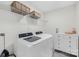 A well-equipped laundry room with a washer, dryer, shelving, and storage space at 146 Allenton Way, Statesville, NC 28677