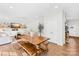 Open-concept living room features a wooden dining table, white walls, and hardwood flooring at 146 Allenton Way, Statesville, NC 28677