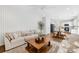 Inviting living room with a large sofa and wooden coffee table, seamlessly connected to the kitchen at 146 Allenton Way, Statesville, NC 28677