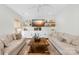 Comfortable living room with white couches, built-in shelving, and a large screen TV at 146 Allenton Way, Statesville, NC 28677