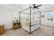 Spacious main bedroom featuring a four-poster bed, ceiling fan, and large windows for natural light at 146 Allenton Way, Statesville, NC 28677