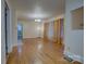 Open-concept living room with wood flooring, a classic chandelier, and a view into other rooms at 154 Bingham Dr, Charlotte, NC 28213