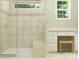Bright bathroom with tiled shower, window, and vanity, showcasing a clean and modern design at 1566 Croydon St, Indian Land, SC 29707
