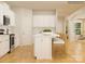 Open kitchen featuring white cabinets, an island with counter seating, and wood flooring at 1566 Croydon St, Indian Land, SC 29707