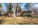 Back exterior and spacious yard featuring a patio and mature trees, creating a serene outdoor setting at 1825 Hyatt Ave, Rock Hill, SC 29732