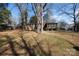 Spacious backyard featuring a patio and mature trees, creating a serene outdoor setting at 1825 Hyatt Ave, Rock Hill, SC 29732