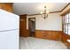 Eat-in kitchen with tile floors, wood paneling, chandelier, and a view to the living room at 1825 Hyatt Ave, Rock Hill, SC 29732