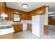 Functional kitchen with wood cabinetry, white appliances, and views of the backyard at 1825 Hyatt Ave, Rock Hill, SC 29732