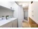Convenient laundry room with white washer and dryer, storage shelving, and easy hallway access at 1825 Hyatt Ave, Rock Hill, SC 29732