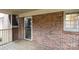 A view of the exterior of the brick house, featuring the screened-in porch at 1825 Hyatt Ave, Rock Hill, SC 29732